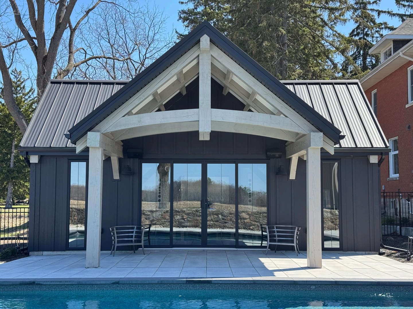 Finished pool-house exterior beside the swimming pool
