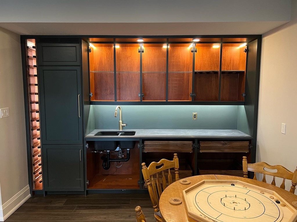 Wet bar during installation, with upper cabinets open and lower doors not yet fitted